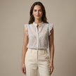 FJØRNA women's floral sleeveless summer blouse worn by a model, light fabric, casual and stylish for warm weather.