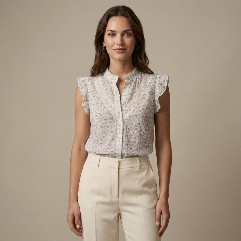 FJØRNA women's floral sleeveless summer blouse worn by a model, light fabric, casual and stylish for warm weather.