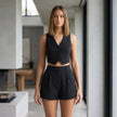 FJØRNA elegant two-piece women's co-ord set with pleated V-neck top and matching pants worn by a model.