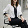 FJØRNA women's summer blouse with V-neck, long chiffon sleeves, worn by model, stylish and lightweight for warm weather.