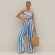 Model wearing FJØRNA ruched strapless bandeau two-piece wide-leg pantsuit with self-tie waist, showcasing stylish and elegant design.