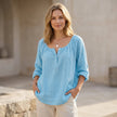 FJØRNA women's summer blouse with V-neck, lightweight linen fabric, flowy and breezy for warm weather.