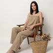Model wearing FJØRNA relaxed coastal camisole and wide-leg pants set, featuring lightweight fabric and casual summer style.