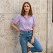 FJØRNA women's summer V-neck short sleeve lace blouse worn by a model, lightweight and stylish for warm weather.