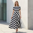 Model wearing FJØRNA A-line striped maxi dress with pockets, featuring a flattering fit and casual style for women.