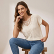FJØRNA women's summer short sleeve knit blouse worn by a model, lightweight and stylish for warm weather.