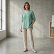 FJØRNA women's summer floral V-neck linen blouse with slit, worn by a model, perfect for warm-weather casual wear.