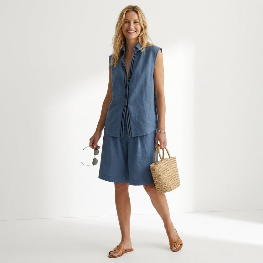 FJØRNA relaxed sleeveless button-up shirt and wide-leg pleated shorts set worn by a model, casual summer fashion ensemble.