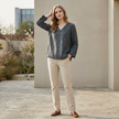 FJØRNA women's summer blouse with a V-neck and slit, featuring lightweight linen fabric and a relaxed fit on a model.