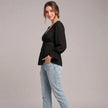 Women's summer blouse by FJØRNA, V-neck linen top with ruffle details, worn by a model.