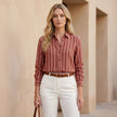 FJØRNA women's summer blouse with long sleeves, striped design, and button front, worn by a model showcasing casual style.