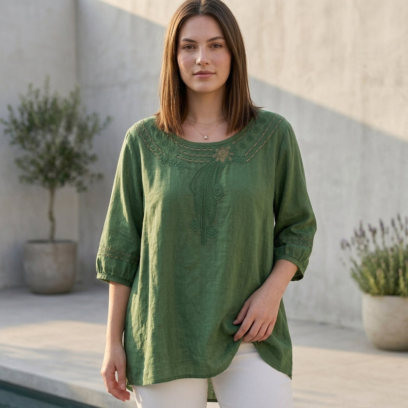 FJØRNA women's summer linen blouse with cut-out design, worn by model, stylish and breathable top perfect for warm weather.