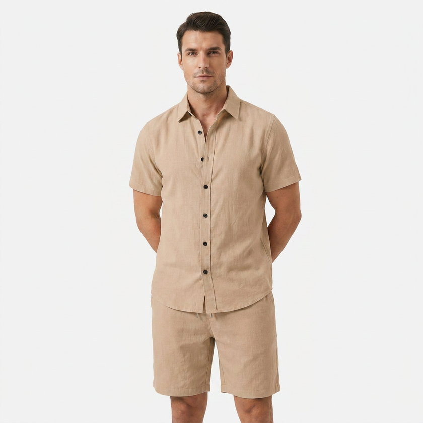 Men's beige linen two-piece set by FJØRNA, featuring a buttoned short sleeve shirt and matching shorts worn by a model.