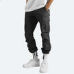 Men's FJØRNA cargo pants with multiple pockets, made of durable fabric, designed for versatile outdoor and casual wear.