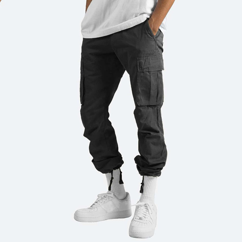Men's FJØRNA cargo pants with multiple pockets, made of durable fabric, designed for versatile outdoor and casual wear.