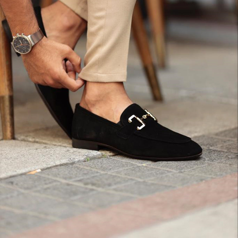 Men's beige suede loafers with horsebit detail and almond toe, by FJØRNA, displayed on a neutral background.