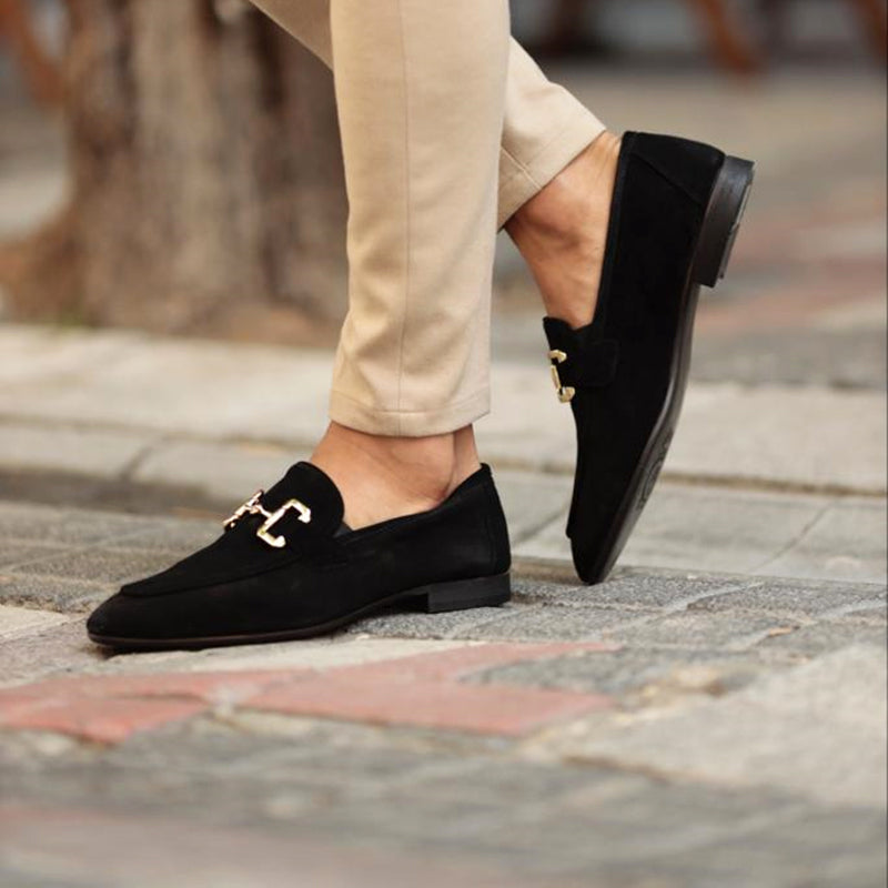 Men's suede horsebit loafers by FJØRNA with almond toe, detailed view of black slip-on shoes.