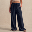 Navy blue women's summer linen trousers with pockets and drawstring waist by FJØRNA, casual and comfortable for warm weather.