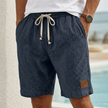 Navy blue men's casual drawstring shorts with pockets and subtle elegant accents, made by FJØRNA.