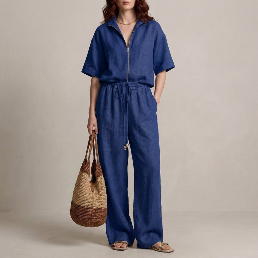 Navy blue FJØRNA 2-piece zip-neck top and wide-leg trouser set, featuring a stylish effortless design and comfortable fit.