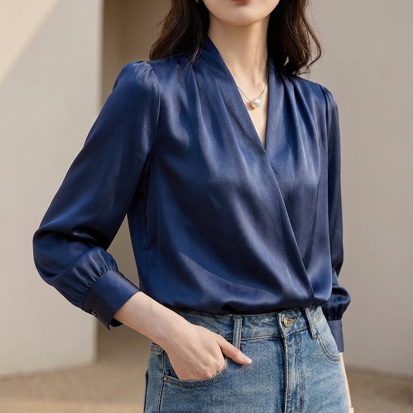 Navy blue women's summer blouse with V-neck, puff sleeves, and pleated design by FJØRNA, perfect for warm weather.