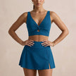 Navy blue women's summer bikini with V-neck and cut-out design, FJØRNA swimwear for stylish beachwear.