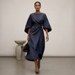 Navy blue FJØRNA batwing sleeve wrap front belted maxi dress with slit, featuring flowing fabric and elegant design.