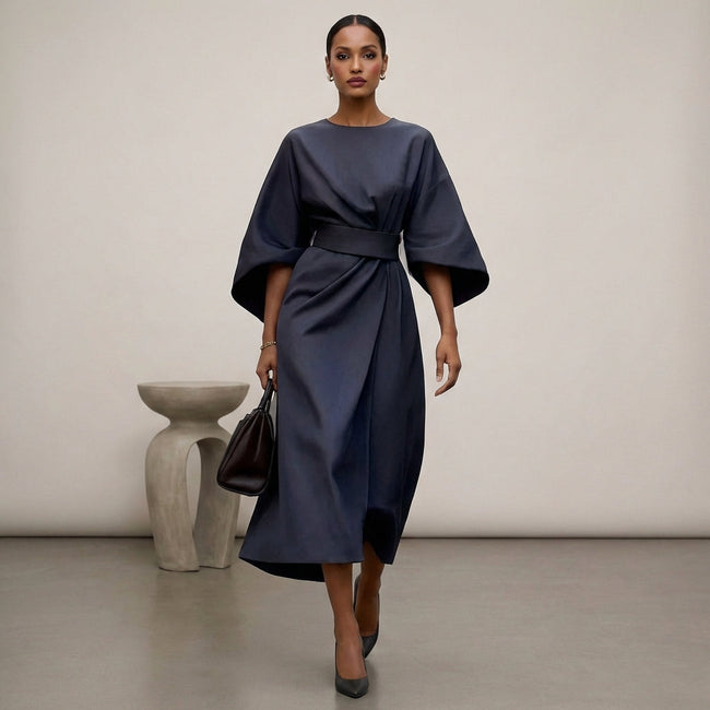 Navy blue FJØRNA batwing sleeve wrap front belted maxi dress with slit, featuring flowing fabric and elegant design.