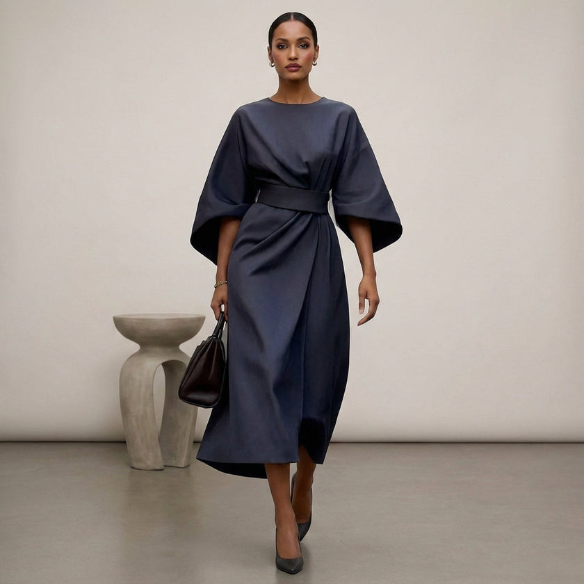 Navy blue FJØRNA batwing sleeve wrap front belted maxi dress with slit, featuring flowing fabric and elegant design.