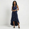 Navy blue satin halter neck wrap maxi dress with bow tie waist and ruffled hem, by FJØRNA, displayed on a mannequin.