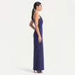 Navy women's one-shoulder maxi evening dress by FJØRNA with an asymmetric neckline, shown from a side view in an elegant pose.
