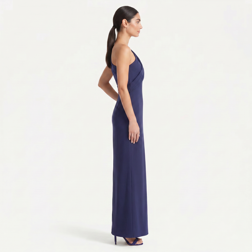 Navy women's one-shoulder maxi evening dress by FJØRNA with an asymmetric neckline, shown from a side view in an elegant pose.