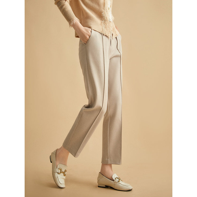 FJØRNA women's tapered wool trousers, stylish pants with a tailored fit and classic design, shown on a model.
