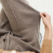 Women’s wide-leg merino wool trousers by FJØRNA featuring high waist and relaxed fit, shown on a model.