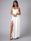 FJØRNA white maxi dress with spaghetti straps, flowing sleeveless design perfect for evening wear, displayed on a hanger.