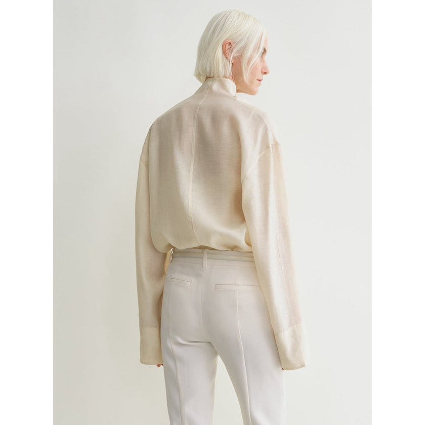 FJØRNA women's linen top featuring a relaxed fit, lightweight fabric, and short sleeves, perfect for casual summer wear.