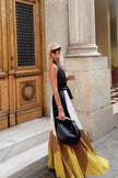 White Polymorphic Maxi Dress by FJØRNA, flowing fabric with elegant design, worn as a stylish summer or evening dress.