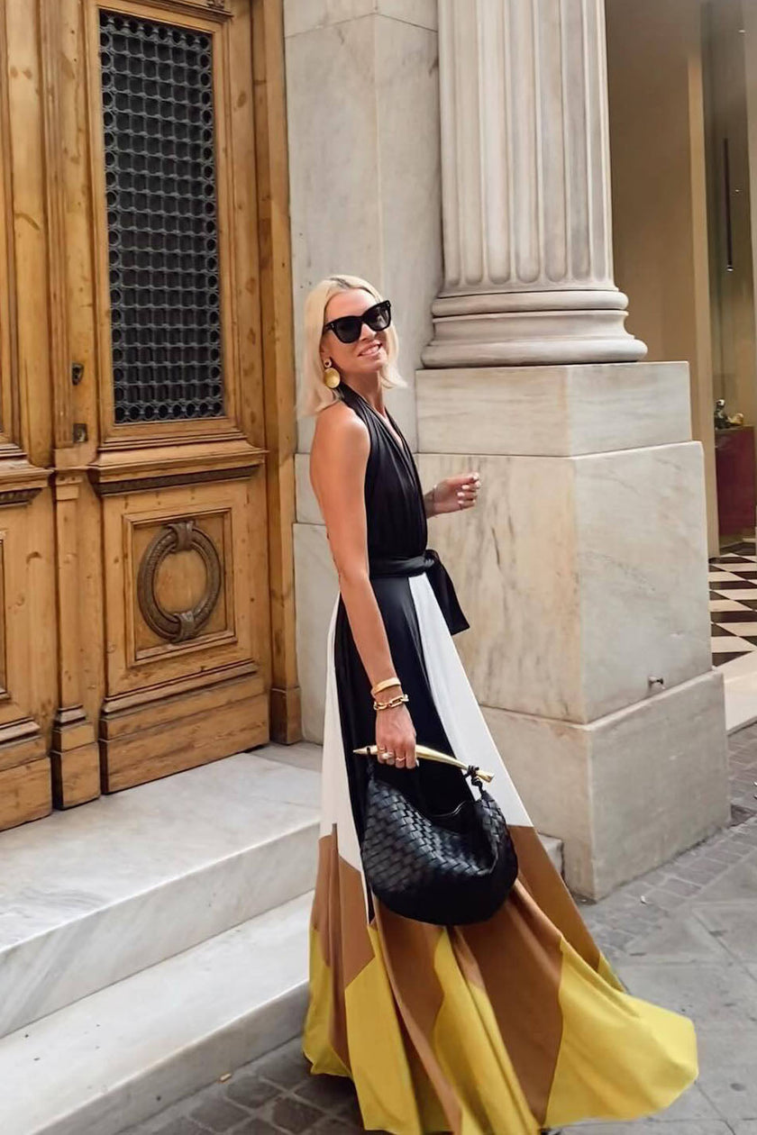 White Polymorphic Maxi Dress by FJØRNA, flowing fabric with elegant design, worn as a stylish summer or evening dress.