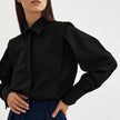 FJØRNA women's cotton blouse, stylish and comfortable top with long sleeves and classic collar, displayed on a hanger.