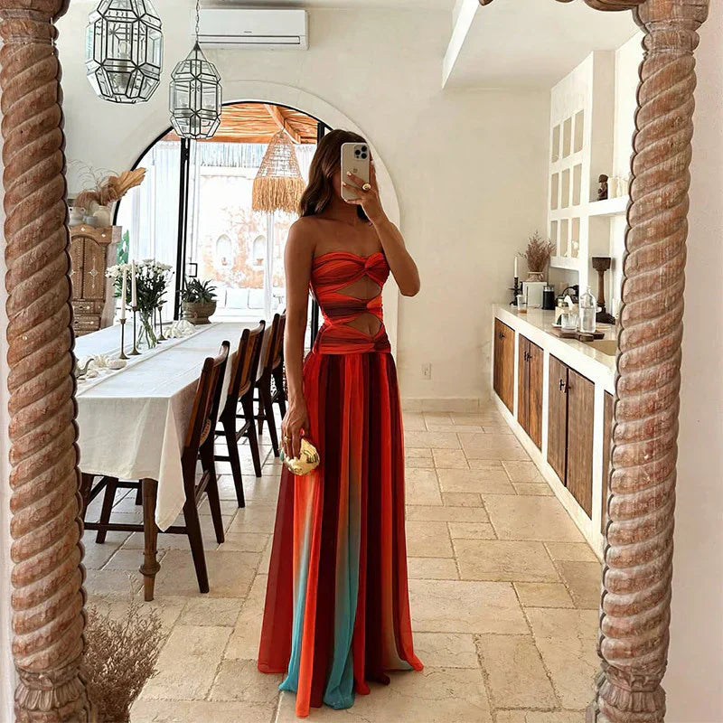 FJØRNA women's elegant maxi dress with geometric strapless design, flowing fabric and stylish silhouette for formal occasions.