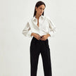 FJØRNA women's cotton blouse, stylish and lightweight tops with a relaxed fit, shown on a model with long sleeves and a collared neckline.