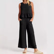 FJØRNA elegant two-piece linen ruffle co-ord set for women, featuring a stylish top and matching skirt in natural linen fabric.