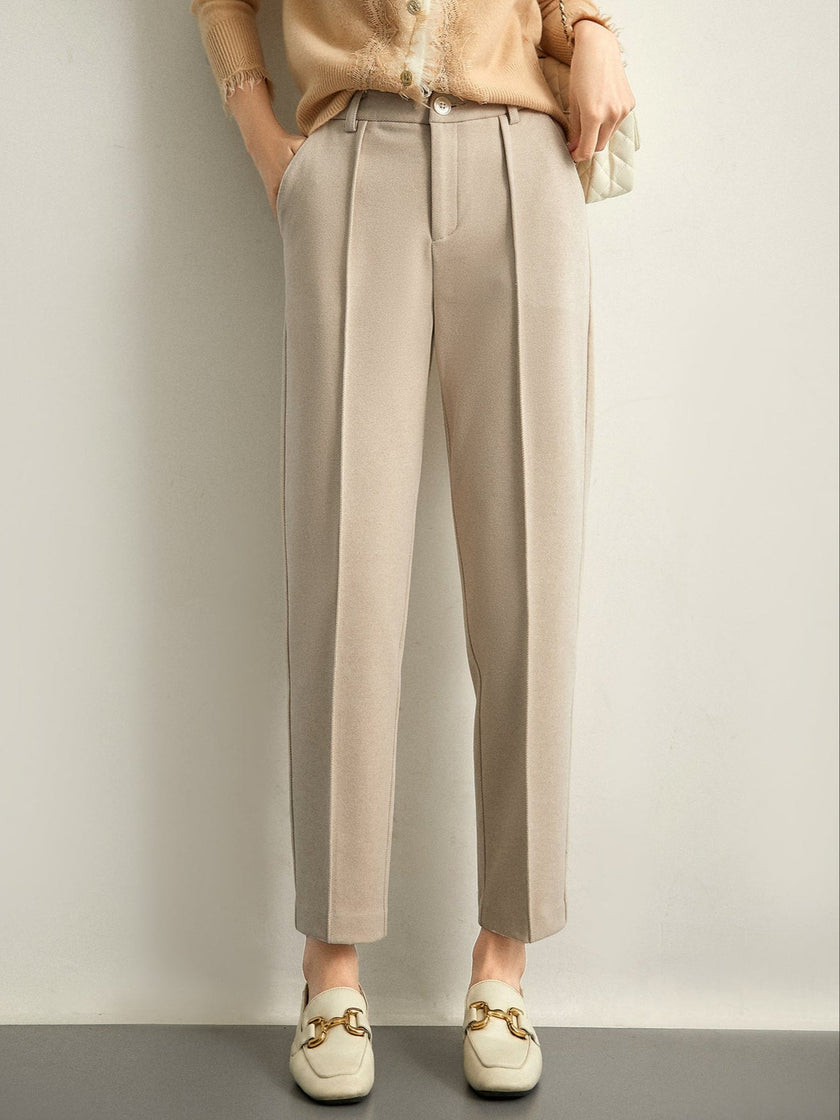 FJØRNA women's tapered wool trousers, stylish and comfortable pants with a tailored fit, shown in a neutral color.