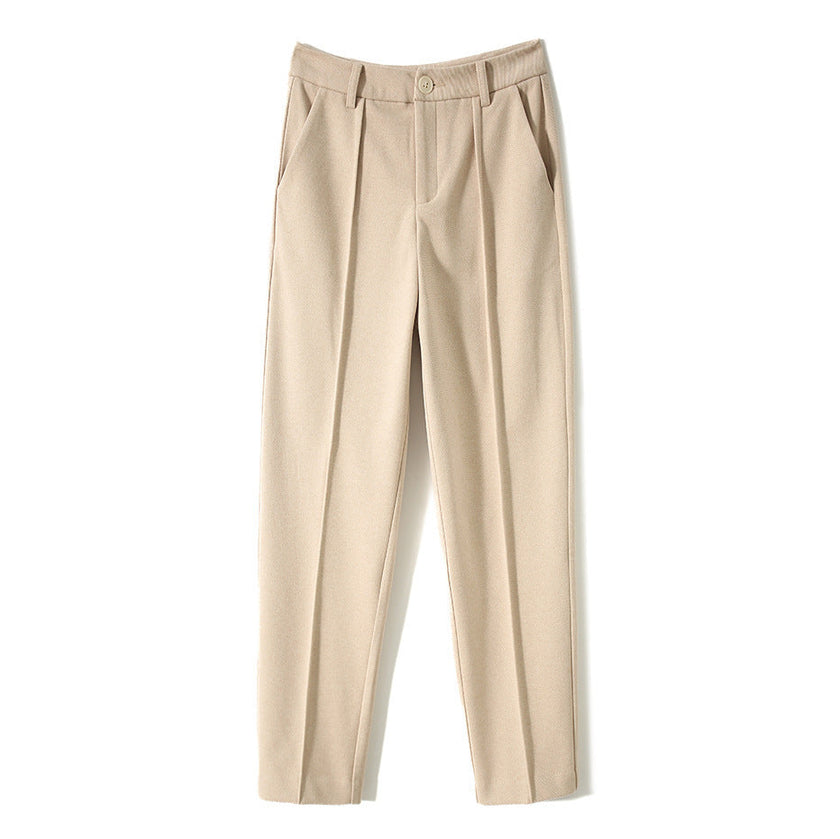 FJØRNA women's wool tapered trousers, stylish and comfortable pants for women, shown in a neutral color on a model.