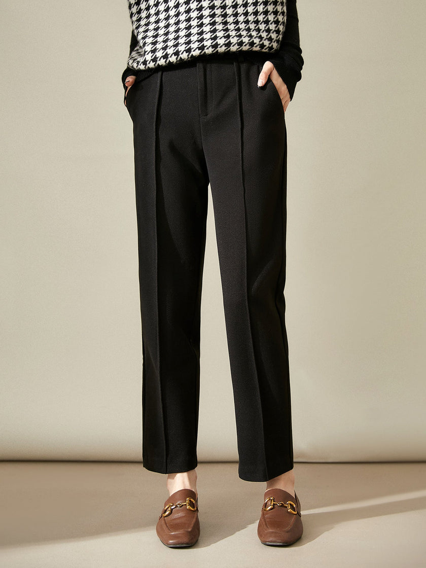 FJØRNA women's wool tapered trousers, stylish and comfortable pants with a tailored fit, showcased in a natural pose.