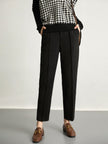 FJØRNA women's wool tapered trousers, stylish and comfortable pants, shown in a natural pose on a plain background.