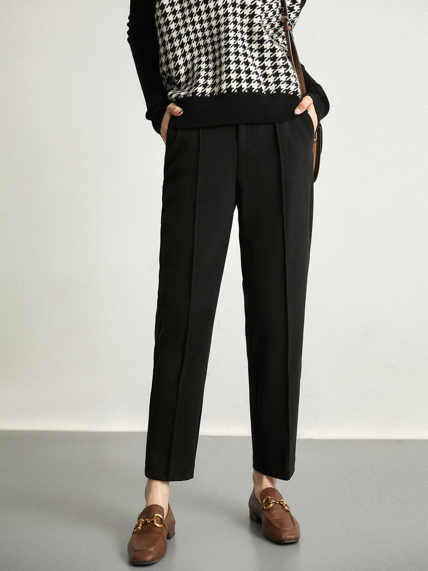 FJØRNA women's wool tapered trousers, stylish and comfortable pants, shown in a natural pose on a plain background.