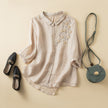 FJØRNA women's floral linen summer blouse with a relaxed fit, showcasing a vibrant floral print and lightweight fabric.