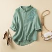 FJØRNA women's floral linen summer blouse with short sleeves and lightweight fabric, perfect for warm weather.