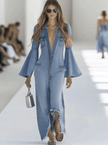 Light blue denim flared jumpsuit with long sleeves and wide-leg design by FJØRNA, shown on a hanger.